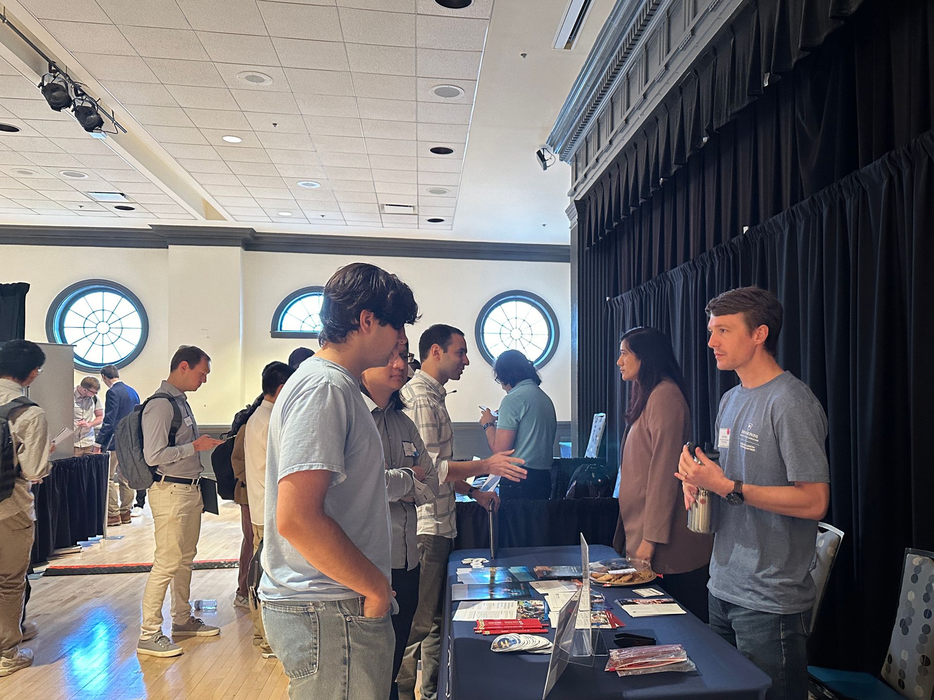 An exhibitor and an attendee talking during the Career Fair at the Quantum Leap Career Nexus.