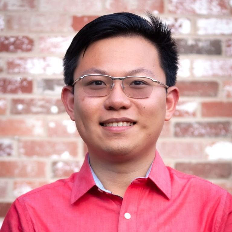 Professional headshot of a man. 