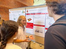 Jarrett Nelson, a rising senior majoring in computer science and minoring in physics and math at Utah Valley University, explains his recent work involving quantum simulations using lasers at a poster session sponsored by the University of Maryland Office of Undergraduate Research. 
