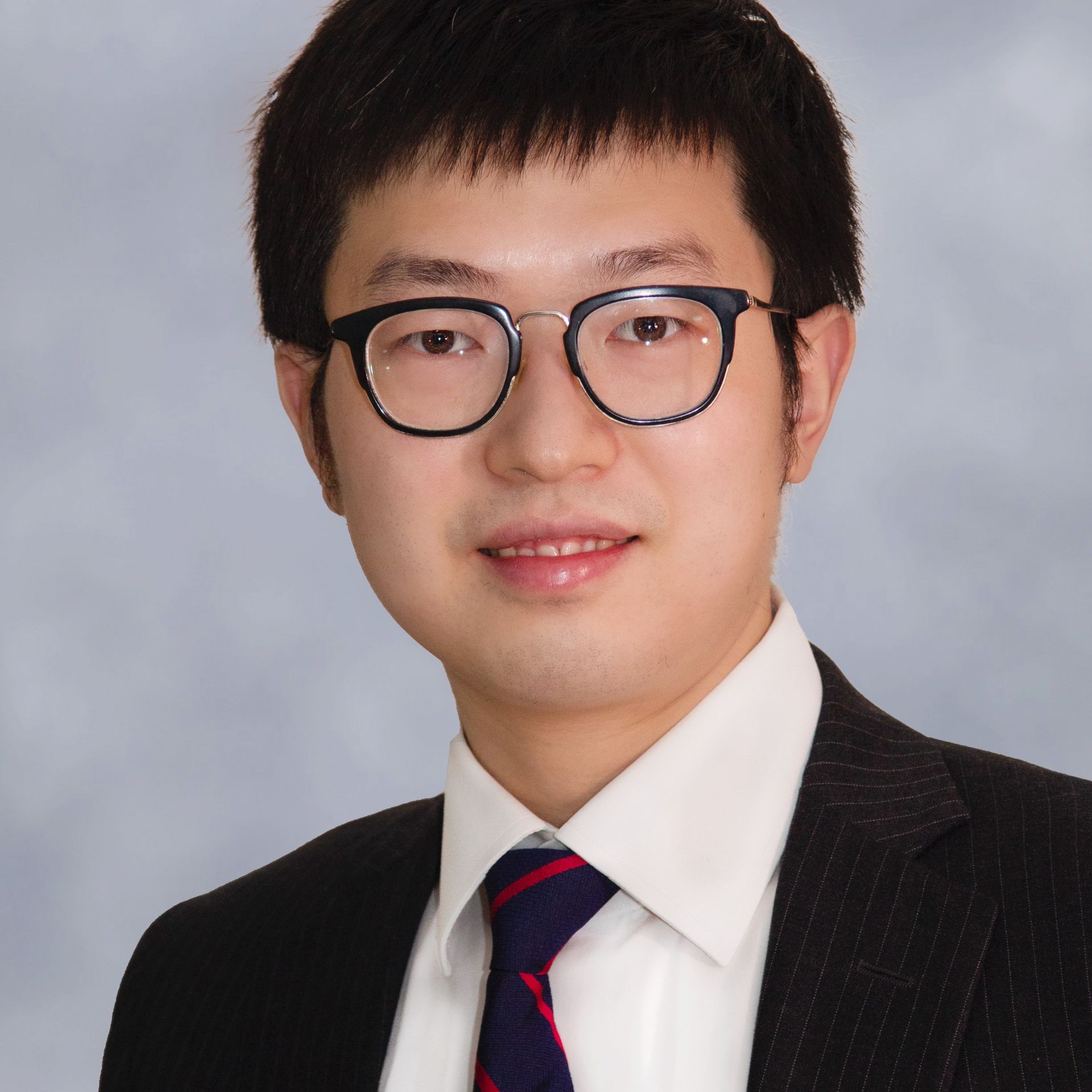 Professional headshot of a man. 