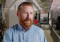 Ian Spielman speaks in an industrial setting.