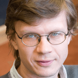 Professional headshot of a man. 