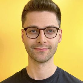 Professional headshot of a man. 